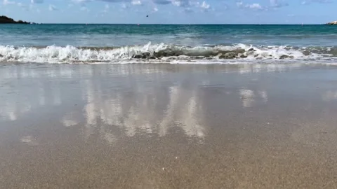 Waves of Mediterranean Sea rolling in sunshine day to the sandy beach. Stock Footage 226136802