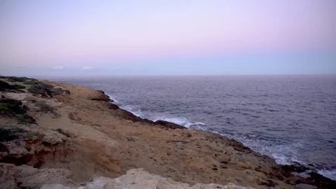 Waves on the Mediterranean Sea. Waves hit the rocks on a rocky shore. Pink Stock-Footage 120074308