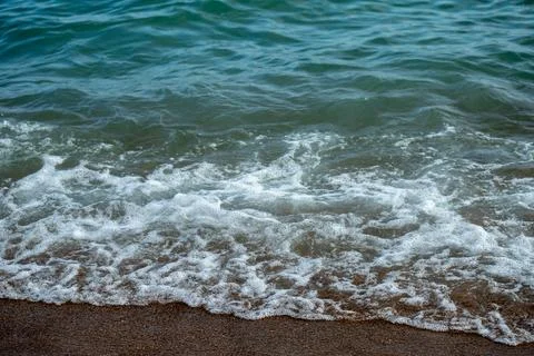 Waves Meeting Sand Stock Photos