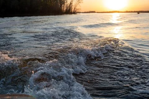 Waves from the motor on the river Stock Photos