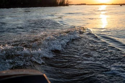 Waves from the motor on the river Fotos de archivo