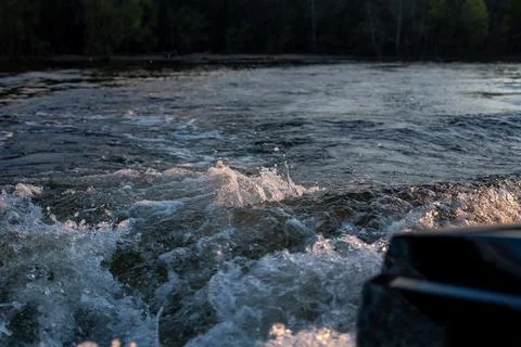 Waves from the motor on the river Stock Photos