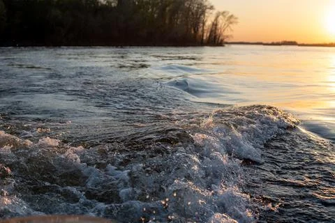 Waves from the motor on the river Stock Photos