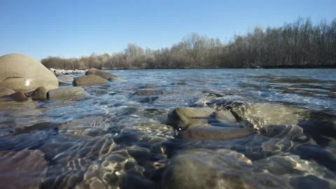 The waves of the mountain perfectly clean river beat against the stone bank. Stock Footage 237709646