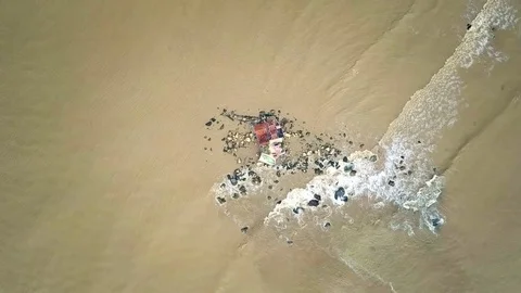 Waves Move by Rolling on Boulders with Temple Aerial View Stock Footage 84846848