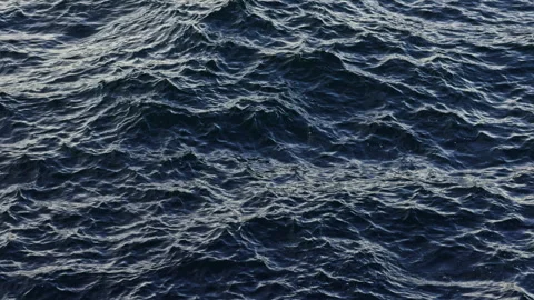 Waves moving across dark ocean water Stock Footage 338301391