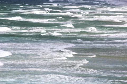 Waves moving to the beach on a windy day Stock Photos