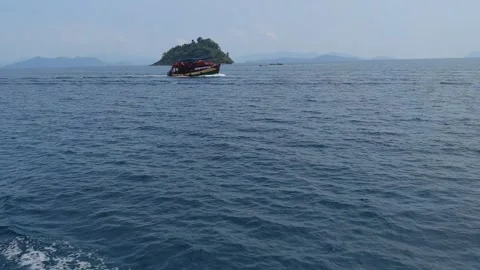 Waves to the moving boat and islands in the ocean Stock Footage 246798456