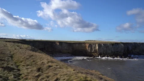 Waves moving towards and hitting cliff face on a windy day in South Shields. Stock Footage