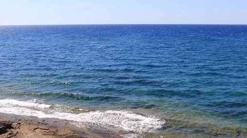 Waves moving towards a rocky beach Stock Footage 92938146