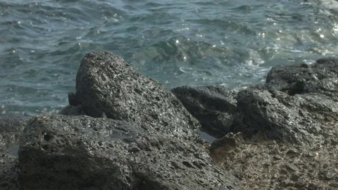 Waves Moving Under Small Rocks Stock Footage 75919554