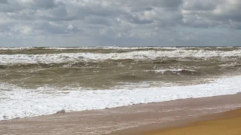 Waves of muddy water on the sandy shore Video stock 81966127