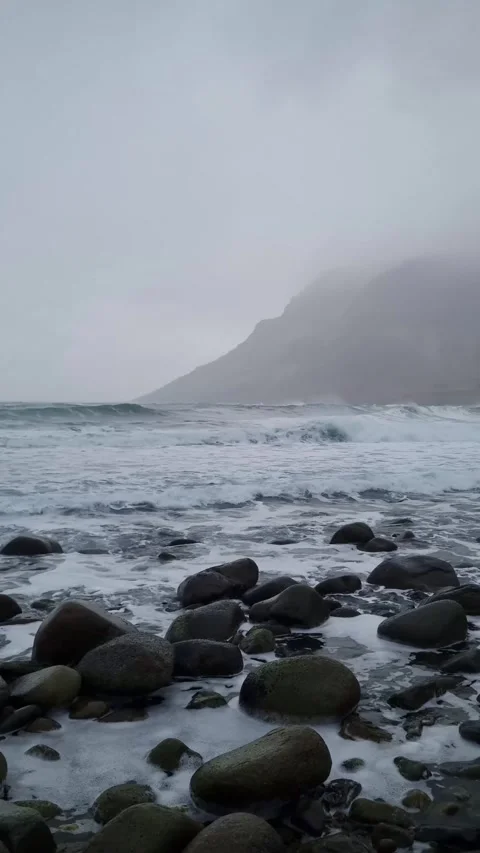 Waves of Norwegian sea surging on stone rocks at Unstad beach, Lofoten islands, Video stock 319847607