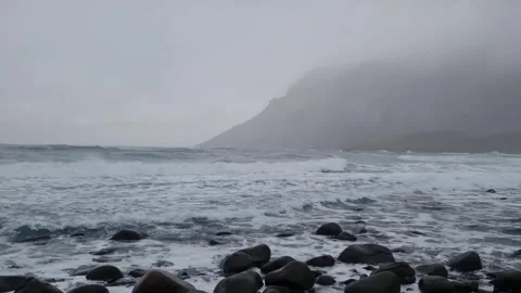 Waves of Norwegian sea surging on stone rocks at Unstad beach, Lofoten islands,  Stock Footage 319847612