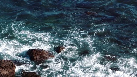 Waves of the ocean are breaking against the rocks  Stock Footage 84005656