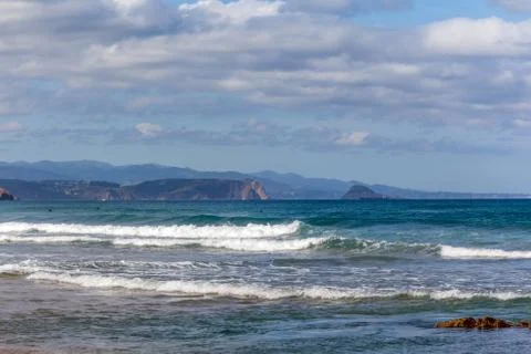 Waves in the ocean on the beach, blue sky Stock Photos