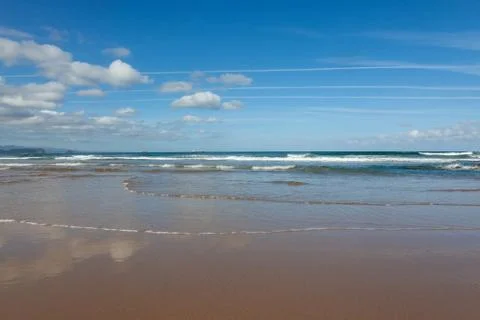 Waves in the ocean on the beach, blue sky Stock Photos