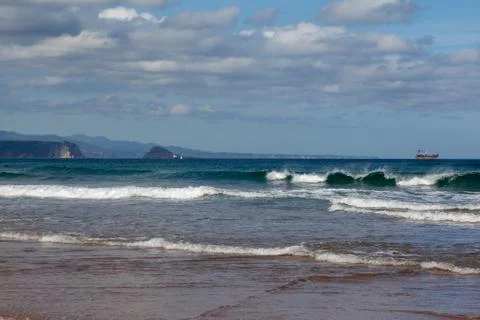 Waves in the ocean on the beach, blue sky Stock Photos