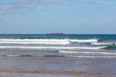 Waves in the ocean on the beach, blue sky Stock Photos