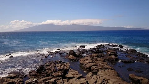 Waves from the ocean beat against cliffs in sunny day on maui,hawaii Stock Footage 100518814