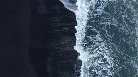 Waves in the ocean. Black sand. Black beach. Waves on the black sand Stock Footage 129394261