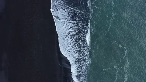 Waves in the ocean. Black sand. Black beach. Waves on the black sand. Stock Footage 129394463