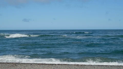 Waves of ocean with blue cloudy sky Stock Footage 112907707