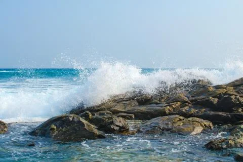 Waves of the ocean break into splashes of dark stones. Southern province. Stock Photos