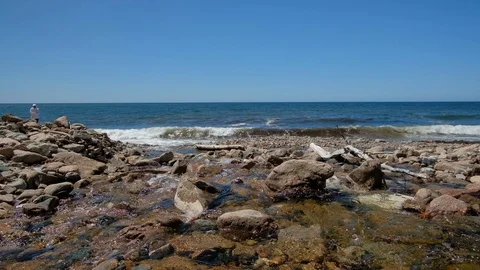 Waves of ocean with rocky coastline Stock Footage 112889396