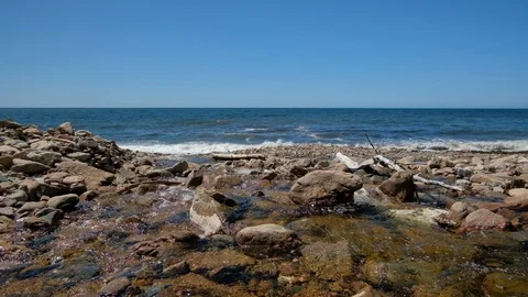Waves of ocean with rocky coastline Stock Footage 112895768