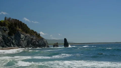 Waves of ocean with rocky coastline Stock Footage 113064233