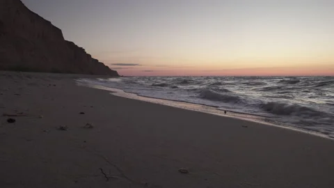 The waves of the ocean roll onto the sandy shore. Stock Footage 138202046
