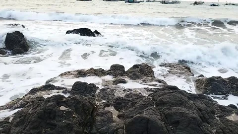 Waves of Ocean splashing on rocks and stones at a beach Coast Vídeo Stock 342698108