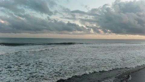 Waves in the ocean at sunset in cloudy weather Stock Footage 229856134