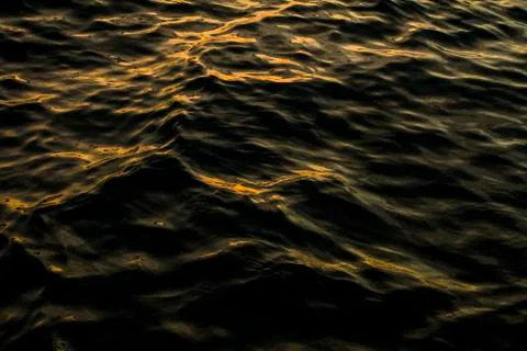 Waves in ocean with sunset colors Stock Photos