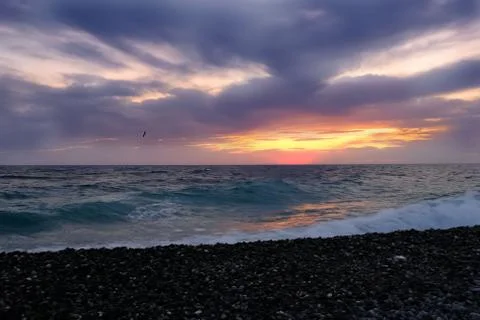 Waves of the ocean surf evening before a thunderstorm. Sunset over the ocean Stock Photos