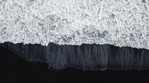 Waves Over Black Sand Beach Stockbeeldmateriaal 144130551
