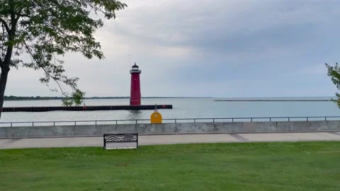 Waves over the lighthouse on Lake Michigan in Kenosha, stone wall with clouds Stock Footage 163830053