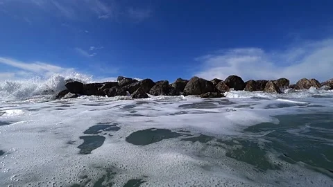 Waves over wavebreaker, slow motion Stock Footage 183991676