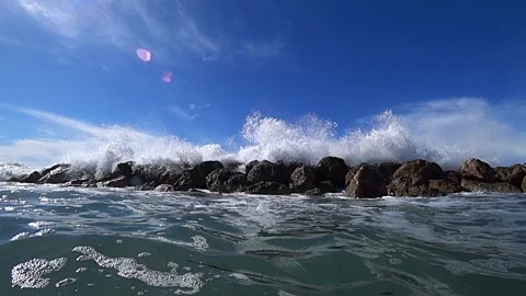 Waves over wavebreaker, slow motion Stock Footage 186494885