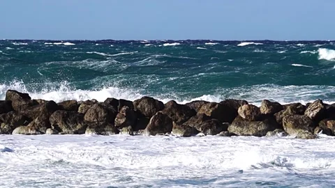 Waves over wavebreaker with strong wind, slow motion Stock Footage 186491447