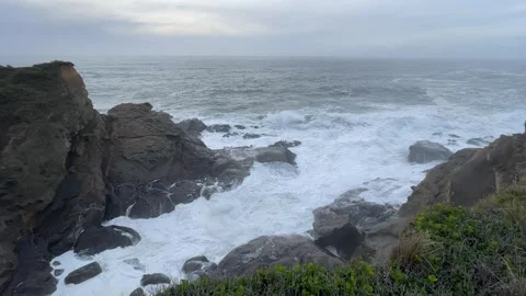 Waves of the Pacific Ocean flow into cove on the Oregon Coast Stock Footage 329448789