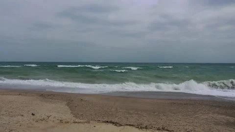 Waves pan over the beach Stock Footage 134011948