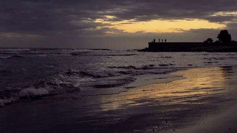 Waves peacefully crash on sand, with a dock. Stock Footage 97468187