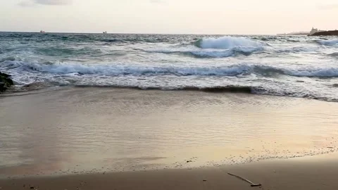 Waves peacefully roll into the sandy shore Stock Footage 153998492
