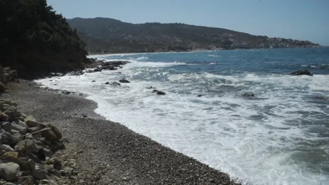 Waves at a pebble and stone beach in Ikaria Video stock 144923676