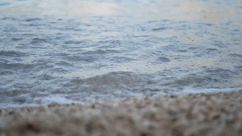 Waves on pebble beach closeup Stock Footage 112825076