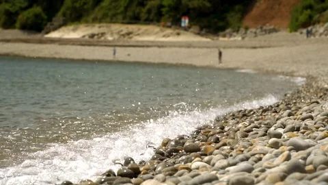 Waves onto pebble beach slow motion Stock Footage 112135711