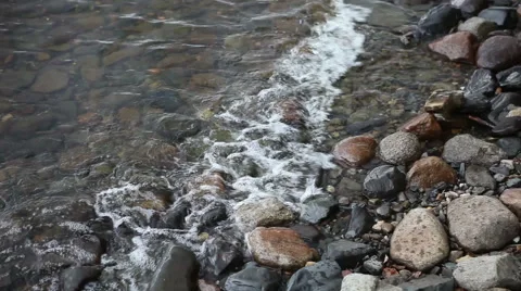 Waves on pebble lake shore Stock-Footage 48910386