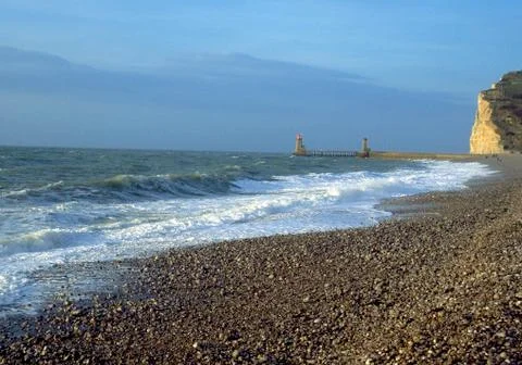 Waves on pebbly beach Stock Photos